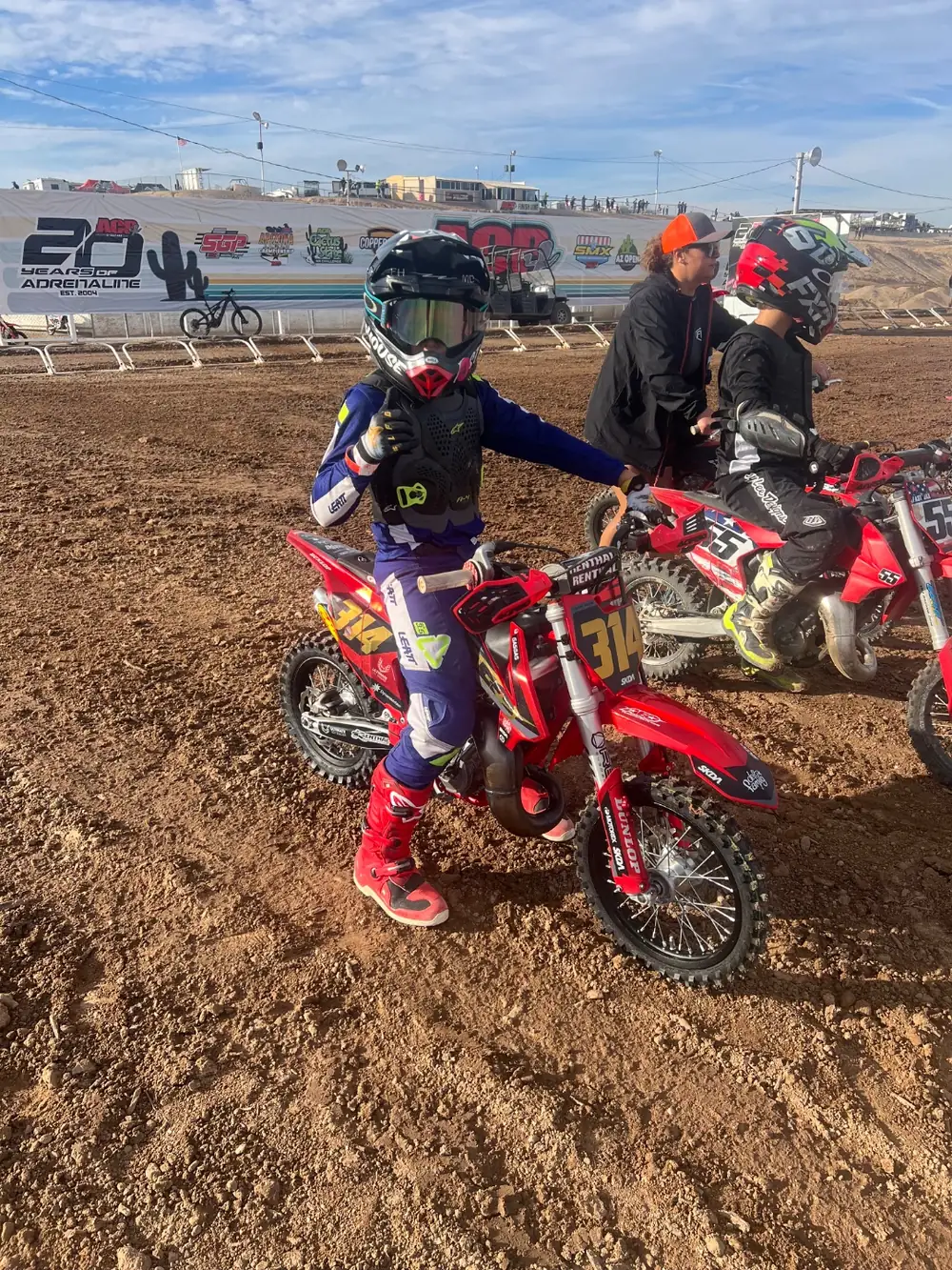 A young rider staged at the starting line at a motocross event