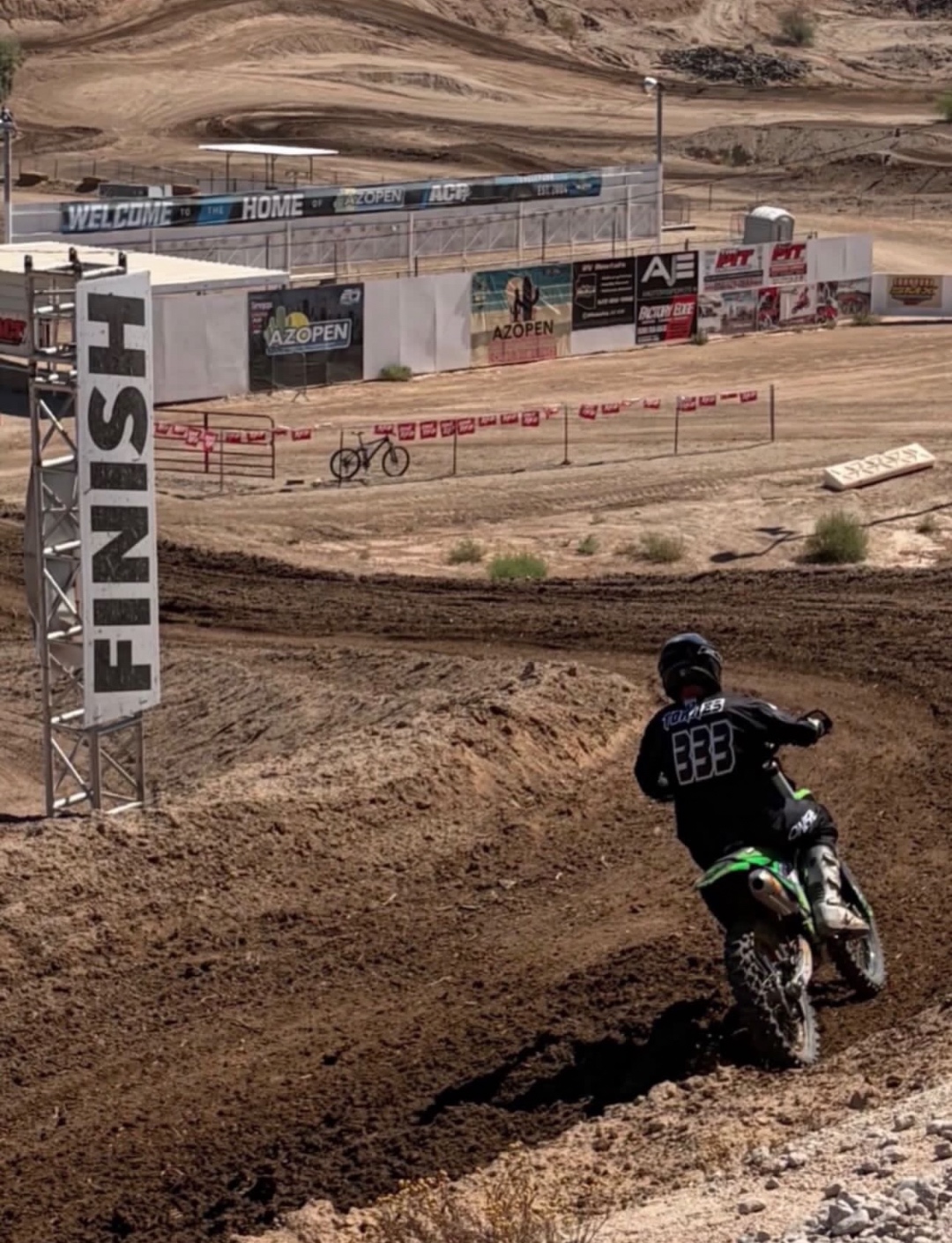 Marty of Punx Moto standing with his motocross bike, bib number 333, at an AZ Open event